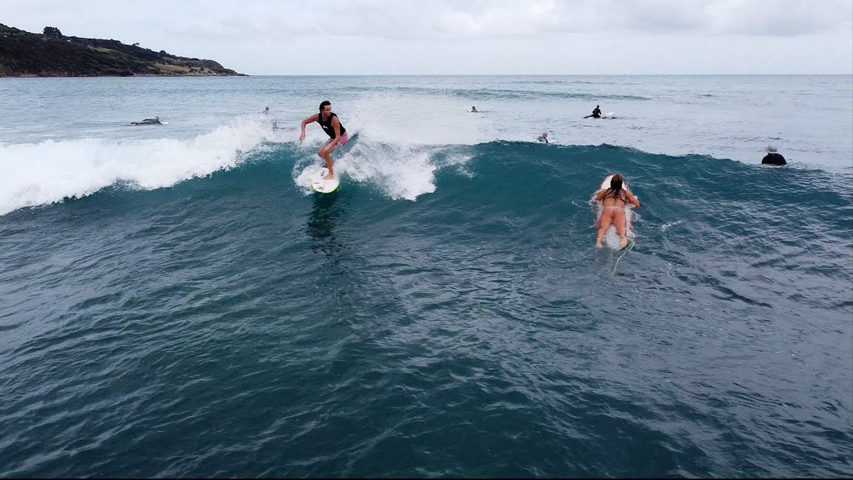Busy mid-summer day at Ngarunui with learners, instructors and locals sharing the lineup. The standard of Raglan surf instruc
