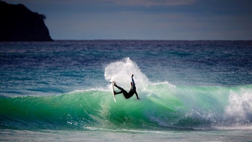 Spray off the lip on a working Pauanui wall, Pauanui surf spot, Coromandel, New Zealand.