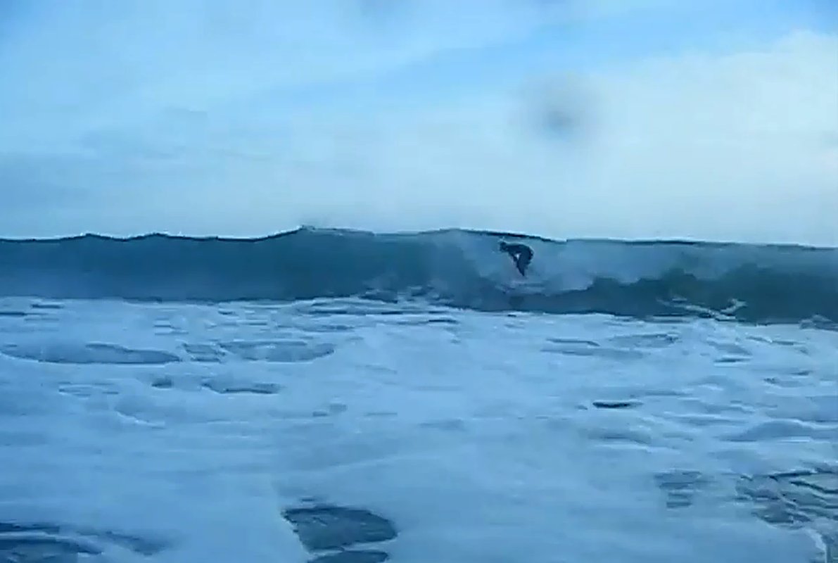 Tucking under the lip on a glassy grey one, the open coast doing its thing, Whangamoa surf spot, Marlborough / Nelson, New Ze