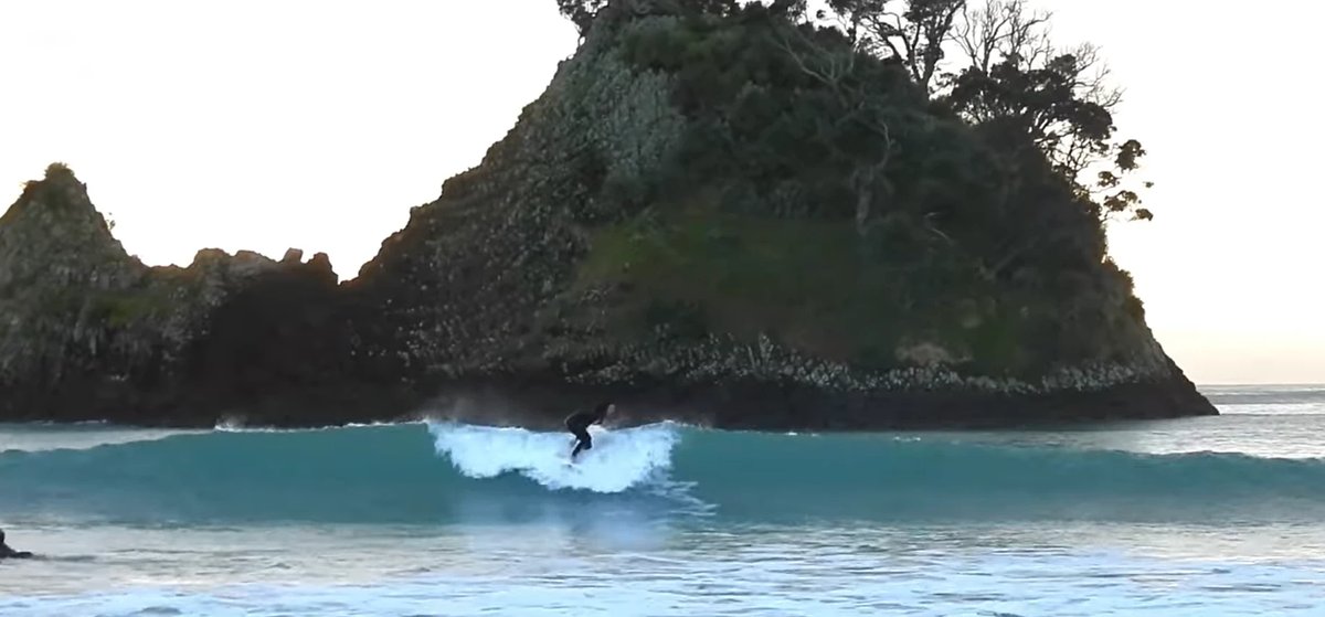 Smaller wave near the rocks at the southern end of Whangapoua, with Pungapunga Island behind, Whangapoua / New Chums surf spo